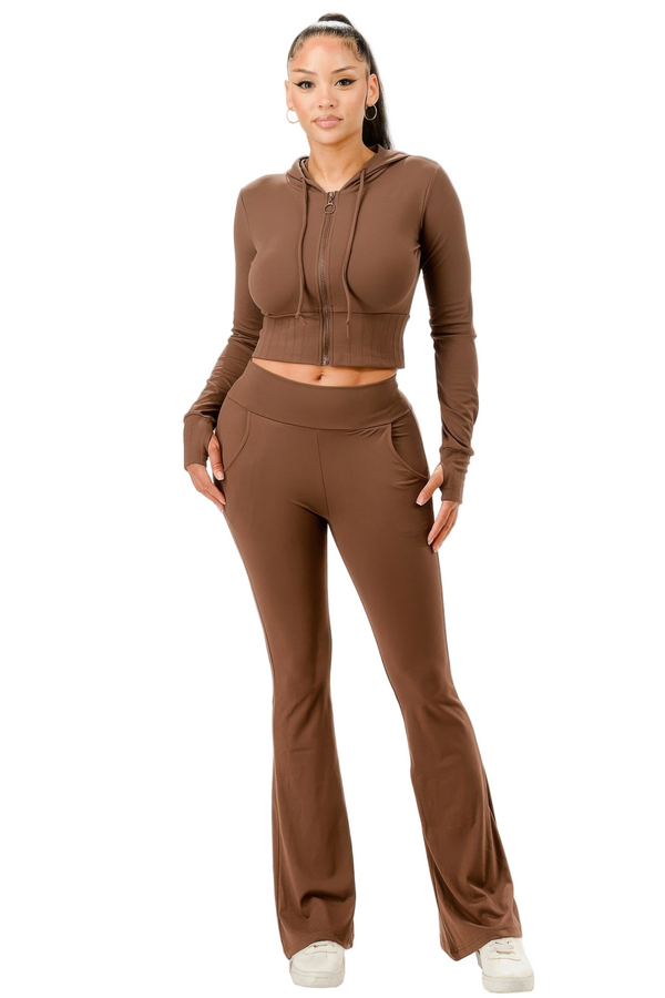 Woman wearing a brown tracksuit on a white background
