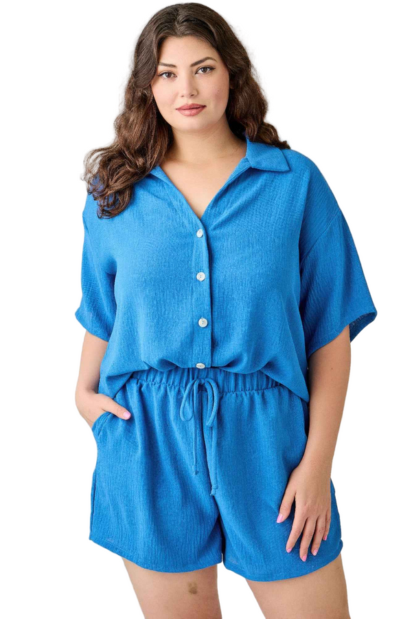 Woman wearing a blue romper on a white background