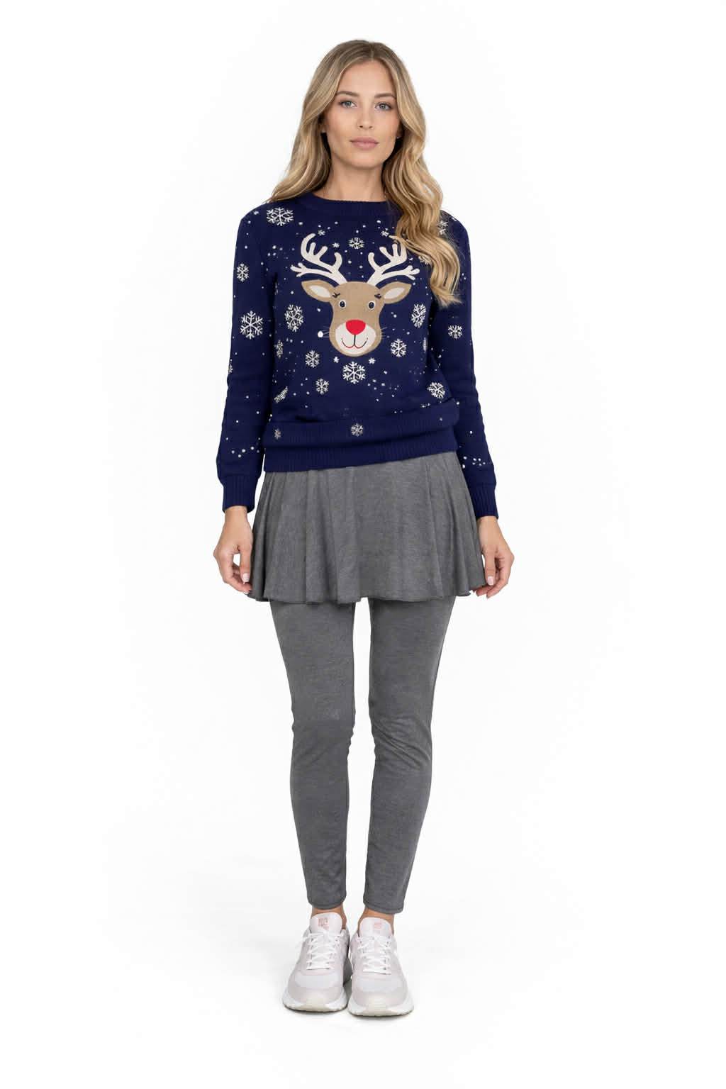 Woman wearing a navy blue sweater with a reindeer design on a white background