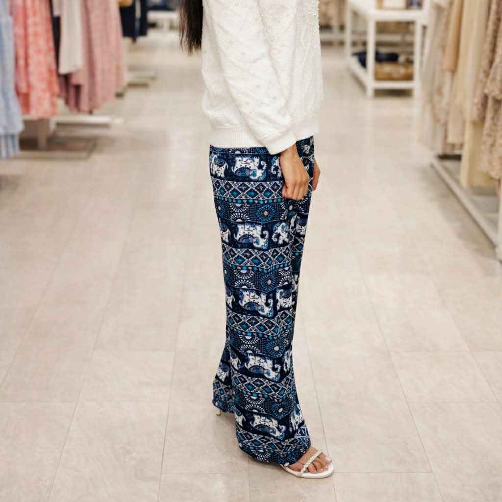 Person wearing blue patterned pants in a store setting