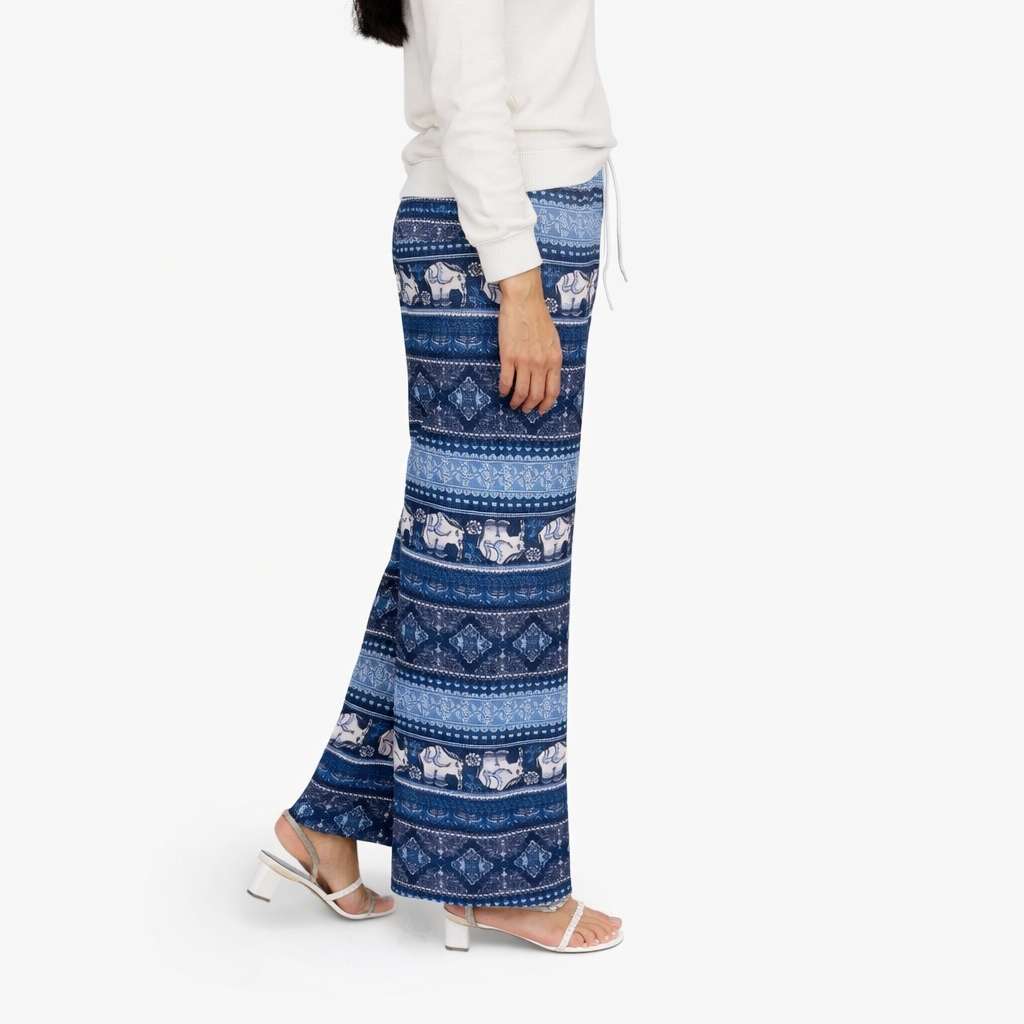 Person wearing blue patterned pants on a white background
