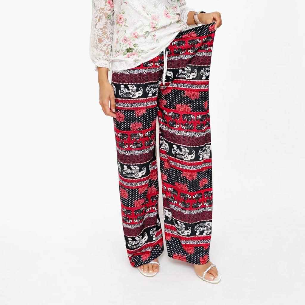 Person wearing a patterned outfit with red and black design on a white background