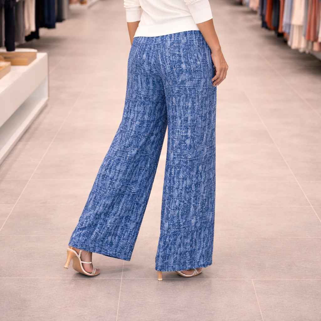 Person wearing blue patterned pants in a store setting