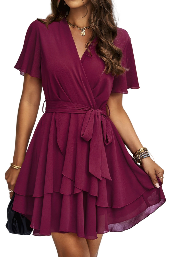 Woman wearing a burgundy dress with a white background