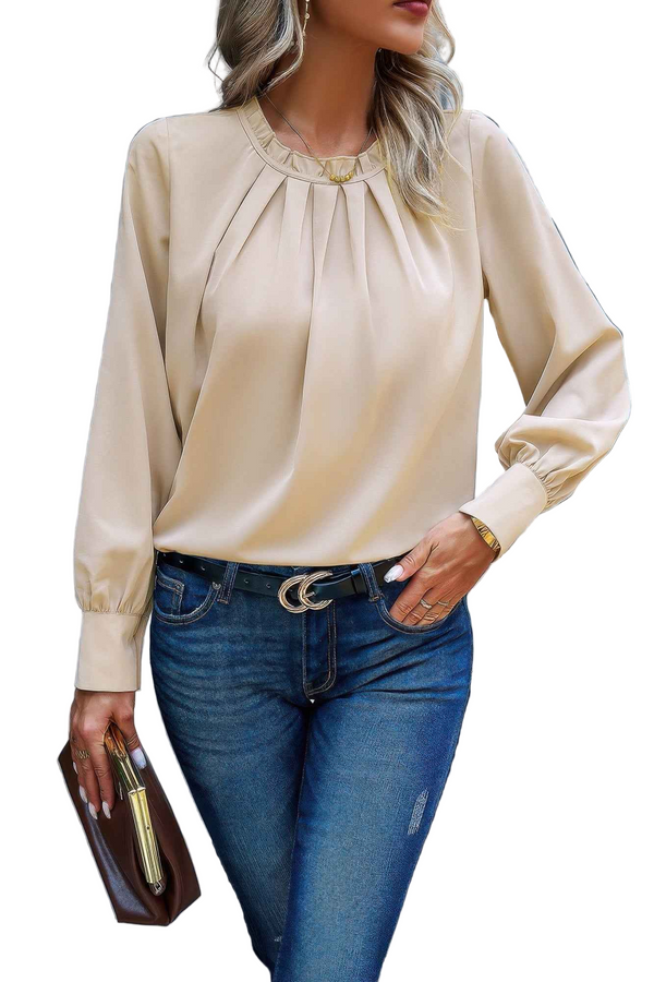 Woman wearing a beige blouse and blue jeans with a white background