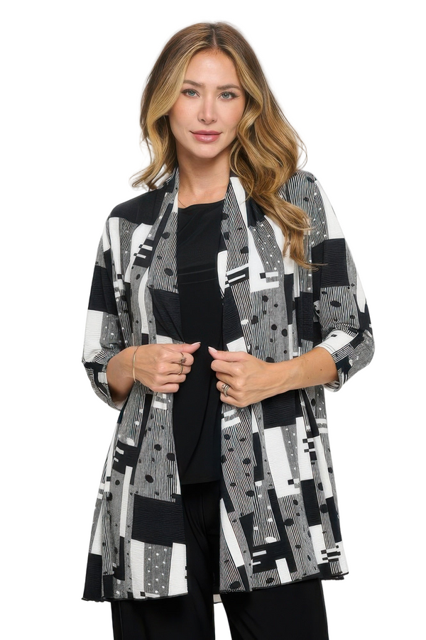 Woman wearing a black and white patterned jacket on a white background