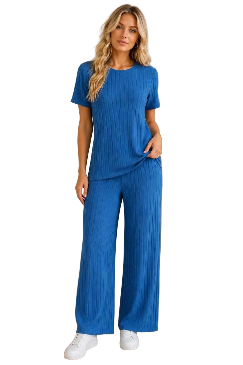 Woman wearing a blue ribbed outfit with wide-leg pants on a white background