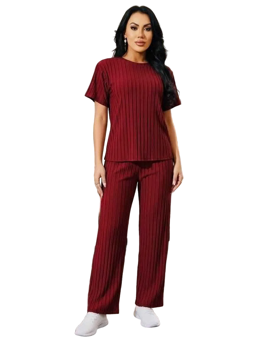 Woman wearing a maroon pleated outfit on a white background